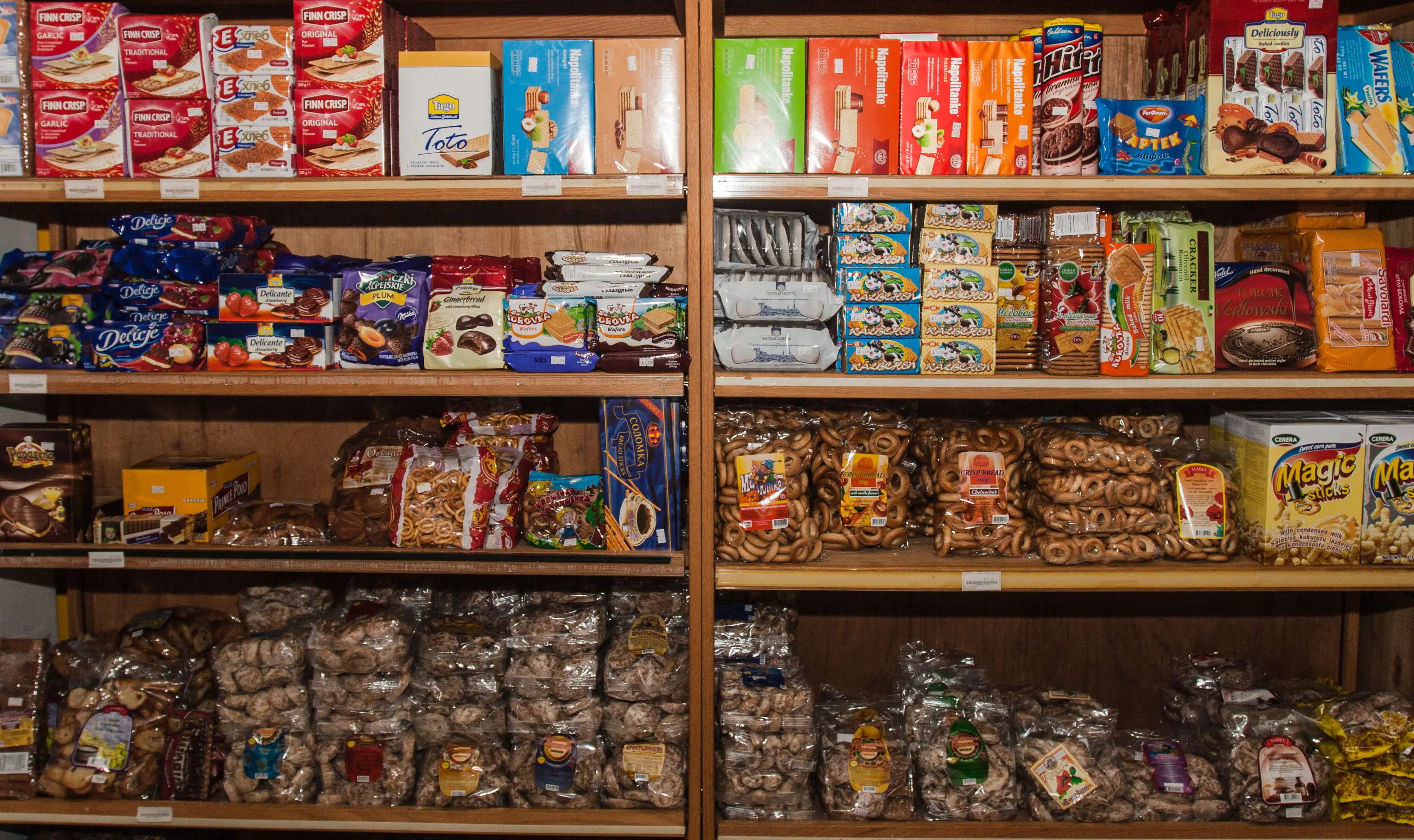 Shelves of cookies, wafers, crispbreads, and packaged baked goods at Aleksey's Market.